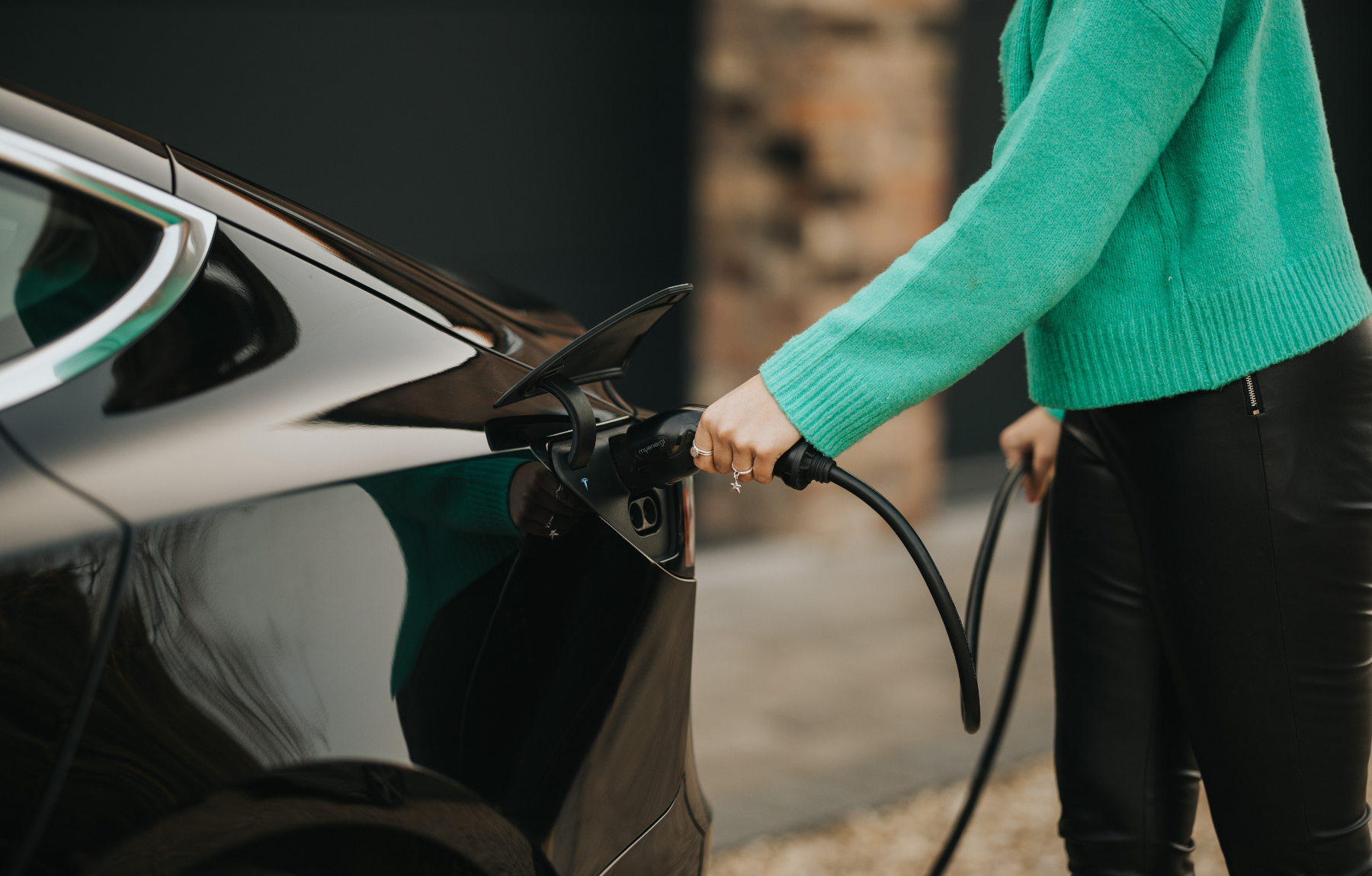 Black Tesla being charged